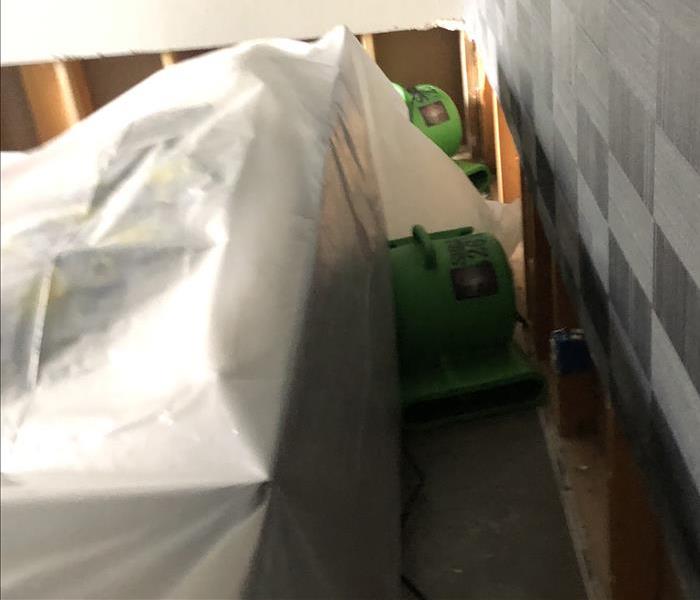 Plastic covering furniture and two green air movers