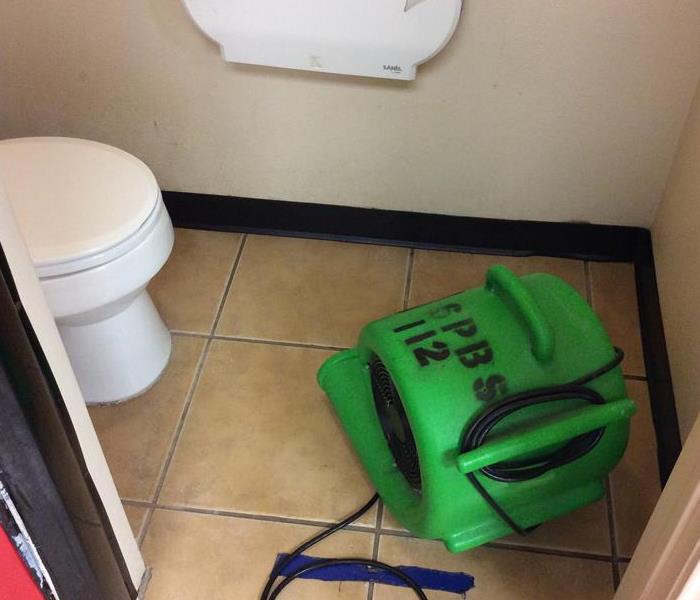 Green air mover in a bathroom with toilet