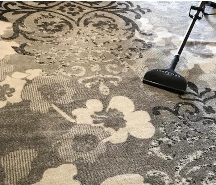 Carpet with flowers and clean on one side with dark soot on the upper side