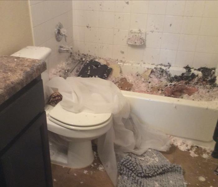 Bathroom covered in drywall from the ceiling after a fire