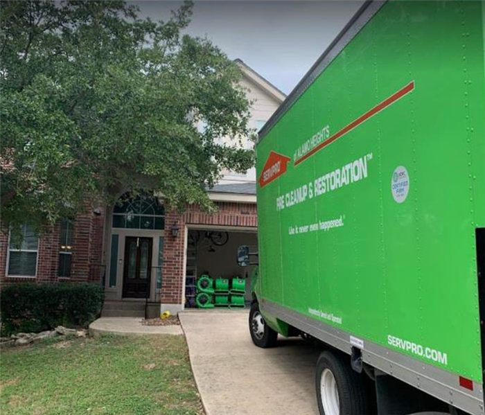 a SERVPRO truck parked in the driveway of a house