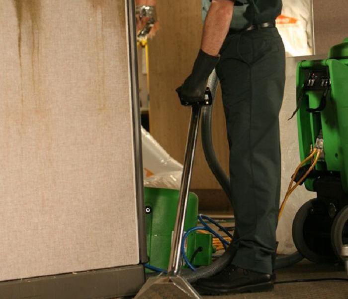 Man using an extractor to extract water