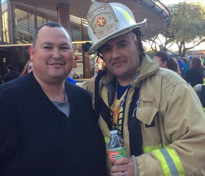 One man next to a firefighter