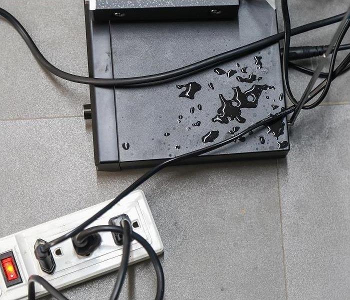 Water spill on electronic equipment, Power strip next to water spill