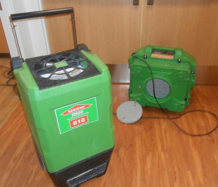 Two green pieces of drying equipment a dehumidifier and an air scrubber